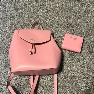 Pink leather Kate Spade backpack and matching wallet.